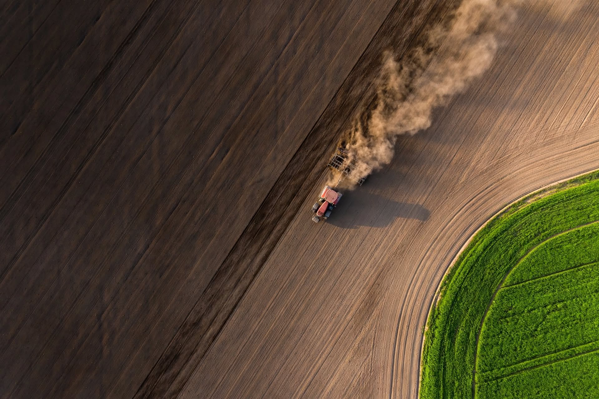 Aerial view of harvester working diagonal crop lines